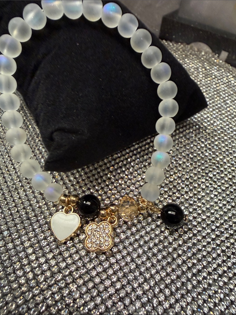 Frosted White Bead Bracelet with Gold Charms and Black Accents
